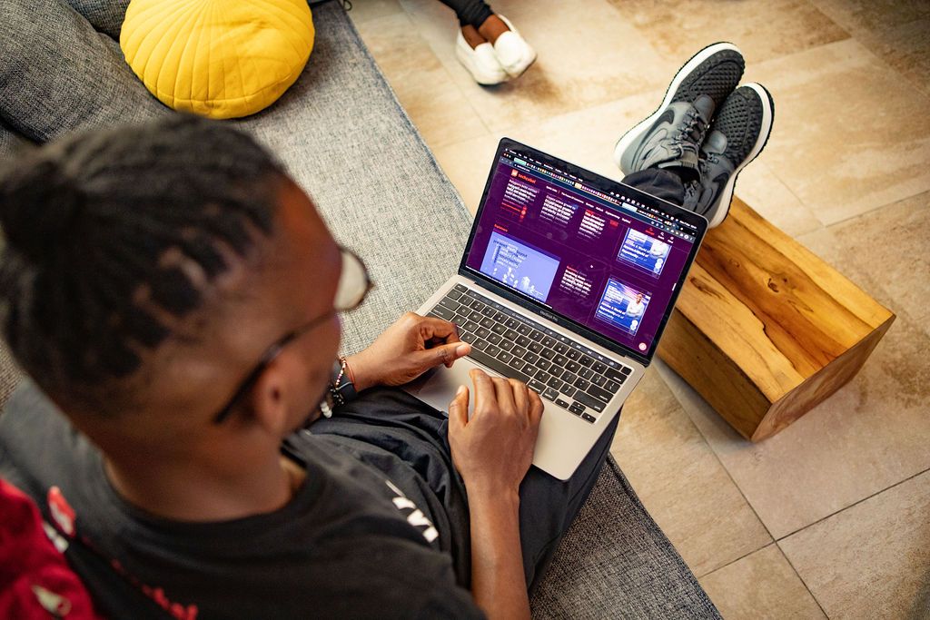 African man visiting TechCabal website using a macbook laptop