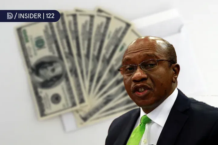 Image showing CBN Governor, Godwin Emefiele in front of dollar notes
